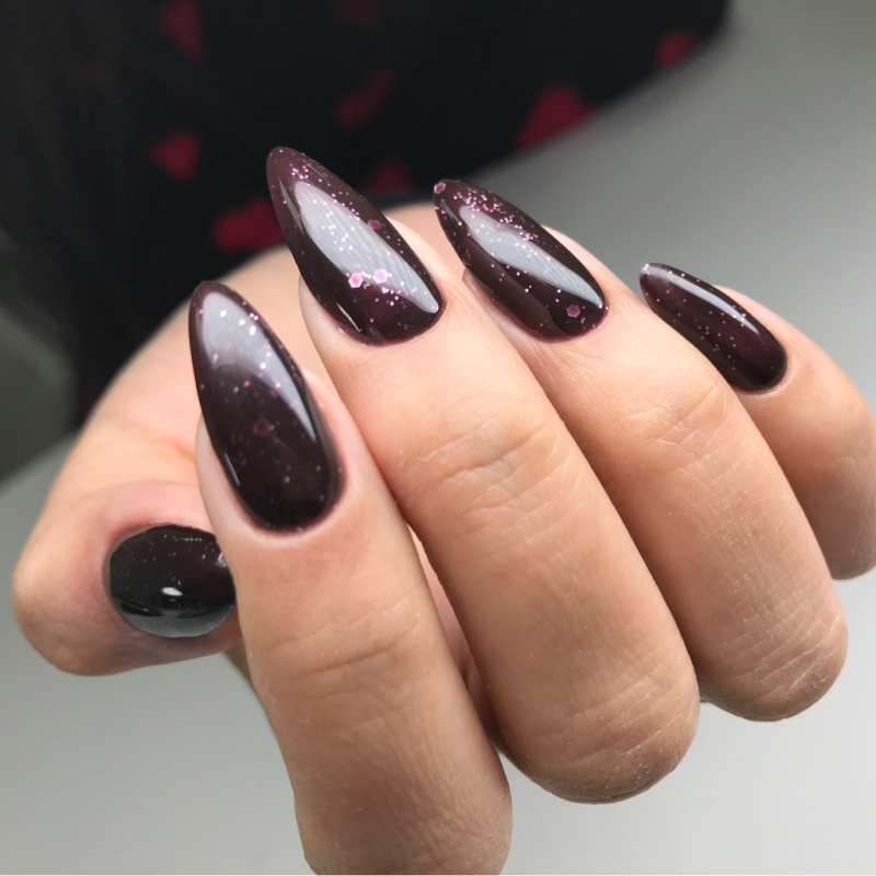 Dark glossy manicure with long almond nails